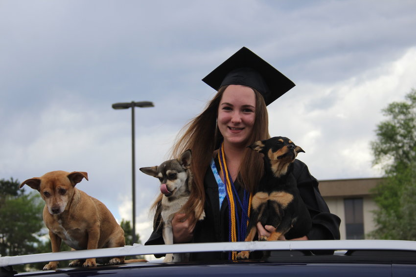 Sage Farrow pops up out of her family's car. Lakewood High School hosted a drive by parade at its campus for the school's 2020 graduates on May 21.
